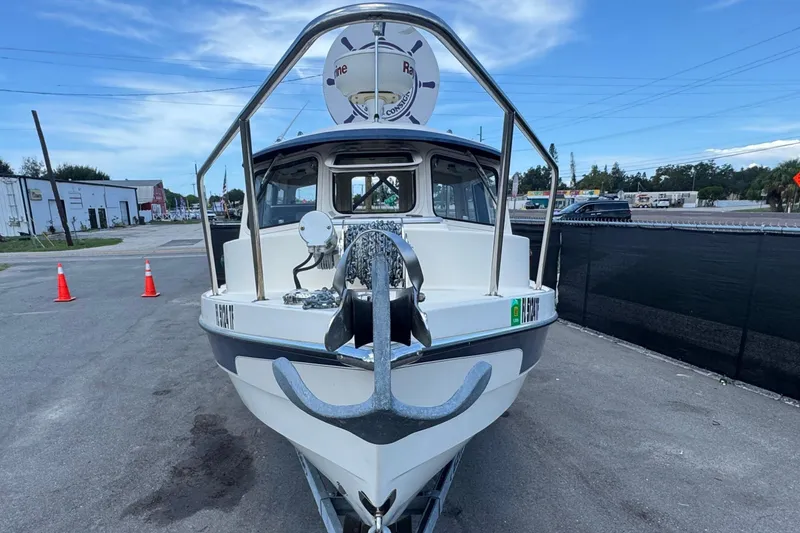 Slide: The Image of 2013 C-Dory 22' Cruiser boat on trailer, parked on asphalt with traffic cones nearby. - 15