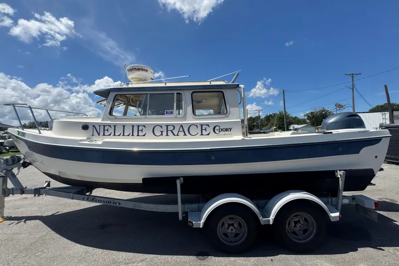 Slide: The Image of 2013 C-Dory 22' Cruiser boat on trailer under blue sky. - 11