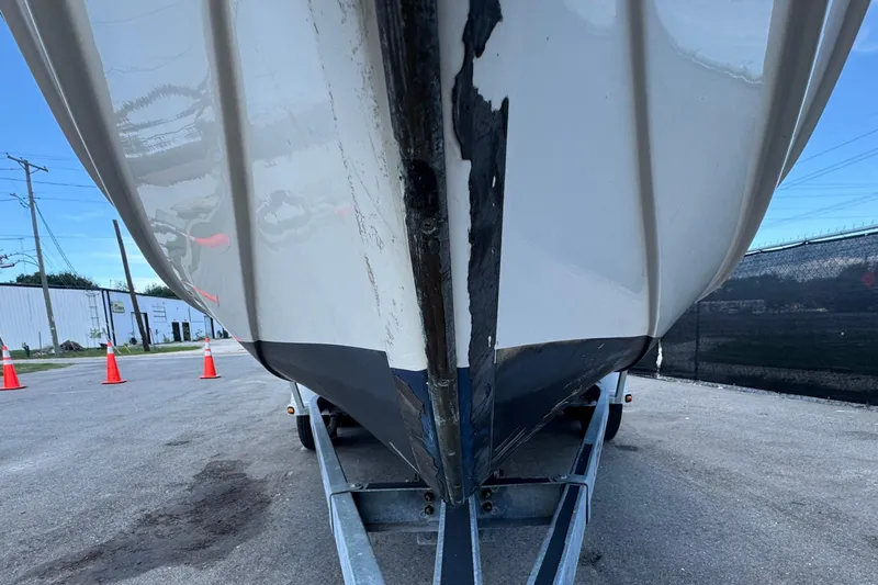 Slide: The Image of 2013 C-Dory 22' Cruiser on trailer, viewed from front, parked on asphalt. - 14