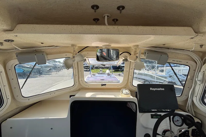 Slide: The Image of Interior view of a 2013 C-Dory 22' Cruiser boat with Raymarine navigation system. - 14