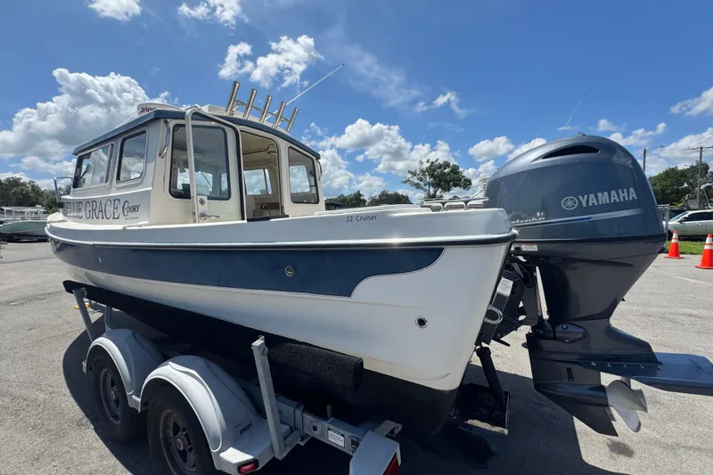 Slide: The Image of 2013 C-Dory 22' Cruiser boat with Yamaha motor on trailer under blue sky. - 10