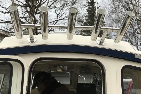 Slide: The Image of 2013 C-Dory 22' Cruiser with rod holders, parked outdoors. - 4