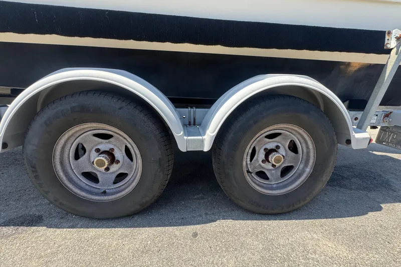 Slide: The Image of Trailer wheels of a 2013 C-Dory 22' Cruiser on pavement. - 55