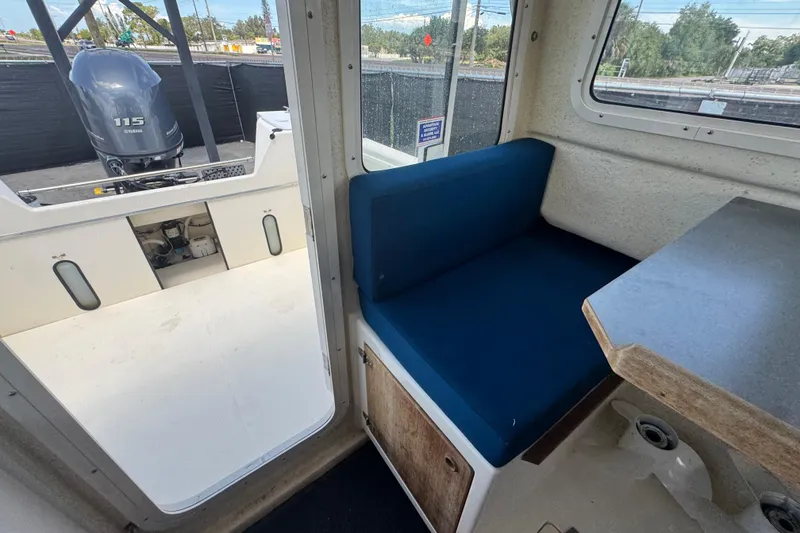 Slide: The Image of 2013 C-Dory 22' Cruiser interior with blue seating and Yamaha 115 engine. - 47