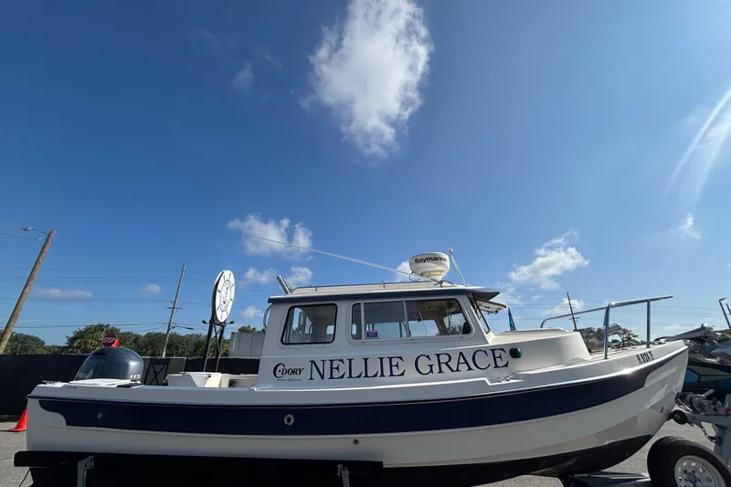 Slide: The Image of 2013 C-Dory 22' Cruiser boat named "Nellie Grace" under a clear blue sky. - 5