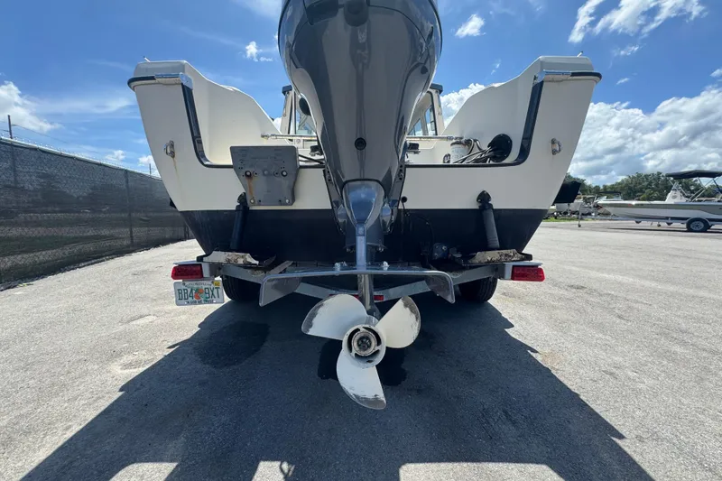 Slide: The Image of Rear view of a 2013 C-Dory 22' Cruiser boat with outboard motor. - 5