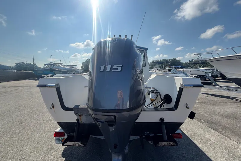 Slide: The Image of 2013 C-Dory 22' Cruiser with 115 HP outboard motor in a sunny marina. - 3