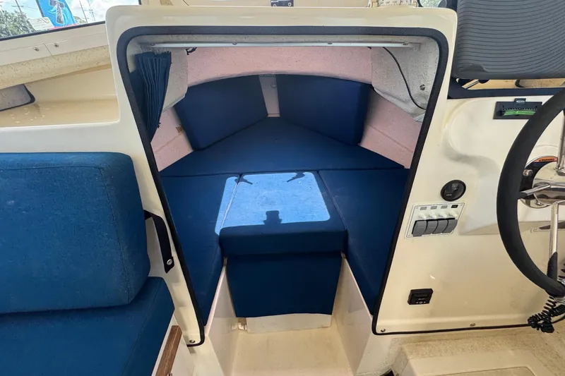 Slide: The Image of The image shows the interior of a 2013 C-Dory 22' Cruiser with blue upholstery. - 39