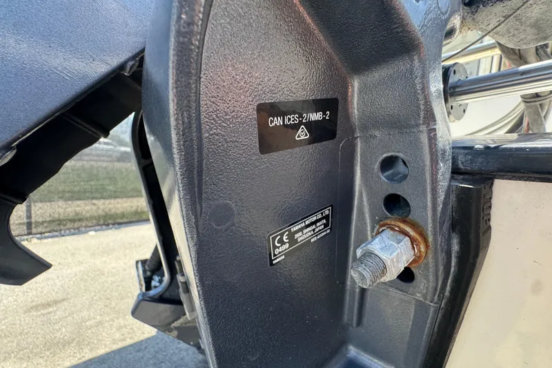 Slide: The Image of Close-up of a 2013 C-Dory 22' Cruiser engine mount with certification labels. - 54