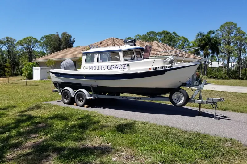 Slide: The Image of 2013 C-Dory 22' Cruiser boat on trailer in residential area. - 0