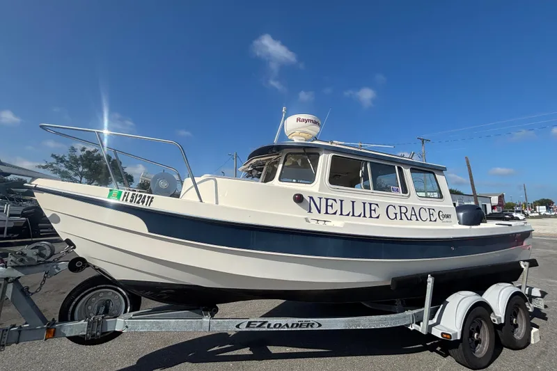 The Image of 2013 C-Dory 22' Cruiser "Nellie Grace" on trailer, clear sky background. - 0