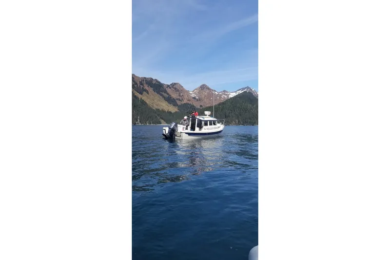 Slide: The Image of 2013 C-Dory 22' Cruiser on scenic lake with mountainous backdrop. - 3