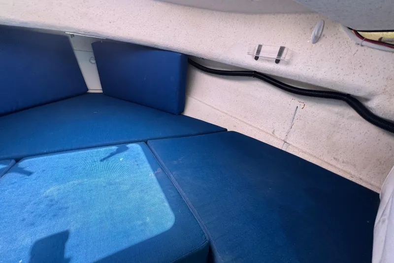 Slide: The Image of Interior cabin of a 2013 C-Dory 22' Cruiser with blue cushions. - 43