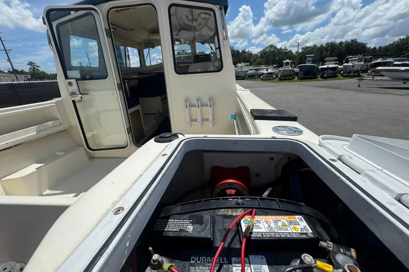 Slide: The Image of 2013 C-Dory 22' Cruiser boat with open cabin and visible battery compartment. - 51