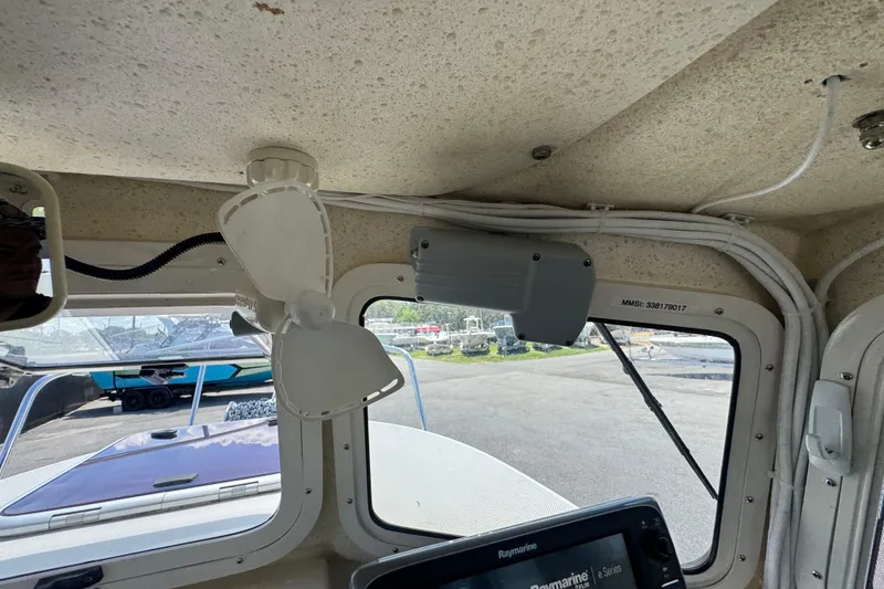 Slide: The Image of Interior view of a 2013 C-Dory 22' Cruiser boat with fan and navigation equipment. - 32