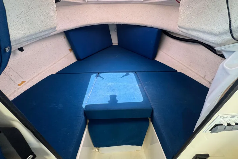 Slide: The Image of Interior cabin of a 2013 C-Dory 22' Cruiser with blue cushions. - 40