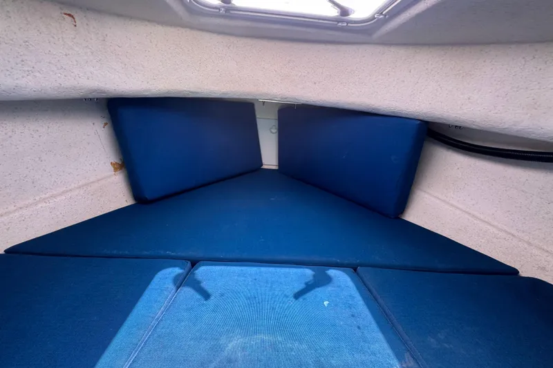 Slide: The Image of Interior cabin of 2013 C-Dory 22' Cruiser with blue cushions. - 42