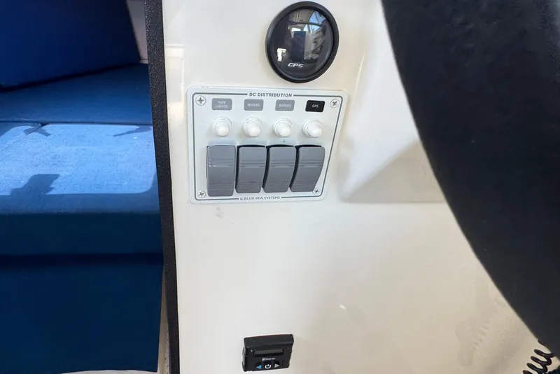 Slide: The Image of Interior view of a 2013 C-Dory 22' Cruiser showing control panel and seating area. - 35