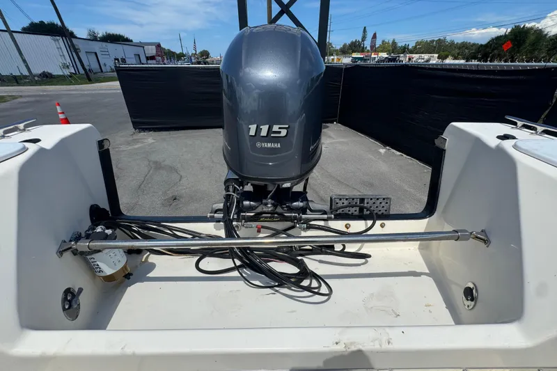 Slide: The Image of 2013 C-Dory 22' Cruiser with Yamaha 115 outboard motor in a parking area. - 49