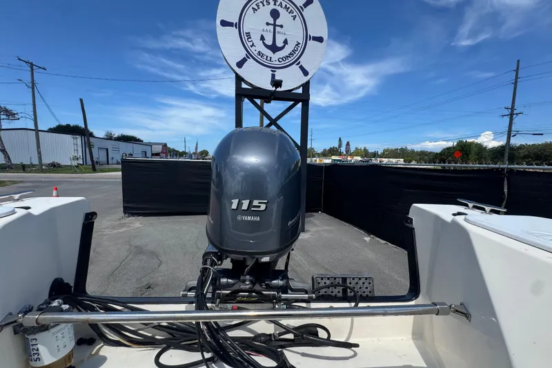Slide: The Image of 2013 C-Dory 22' Cruiser with Yamaha 115 outboard motor at a dealership. - 52