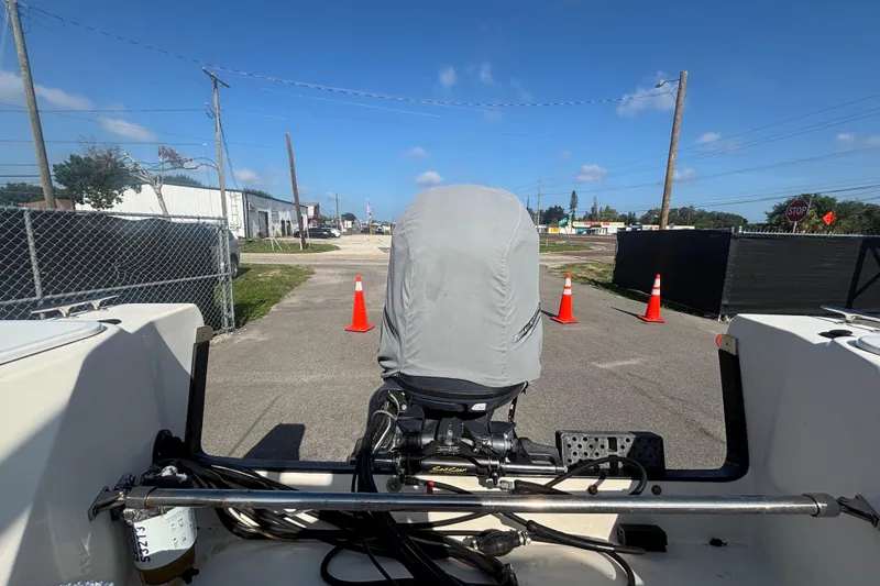 Slide: The Image of 2013 C-Dory 22' Cruiser with covered outboard motor, parked near traffic cones. - 26