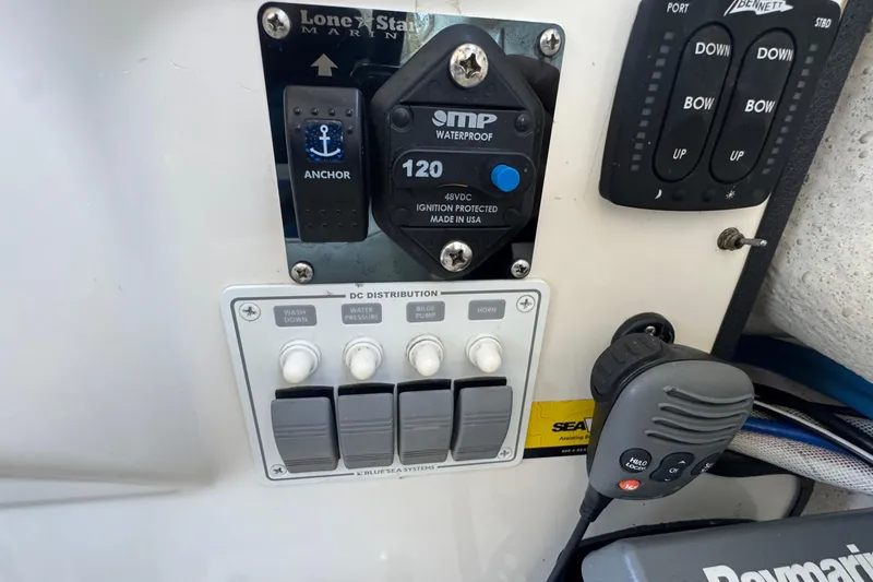 Slide: The Image of Control panel of a 2013 C-Dory 22' Cruiser with switches and marine electronics. - 37