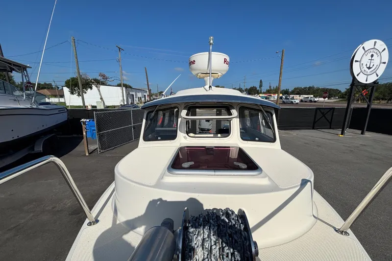 Slide: The Image of 2013 C-Dory 22' Cruiser boat docked, featuring radar equipment and spacious cabin. - 28