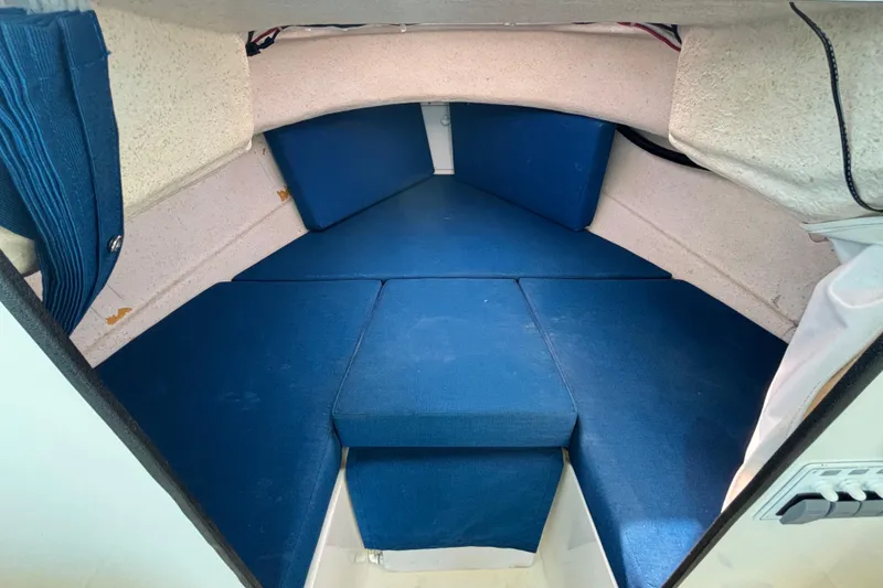 Slide: The Image of Interior cabin of a 2013 C-Dory 22' Cruiser with blue cushions. - 20