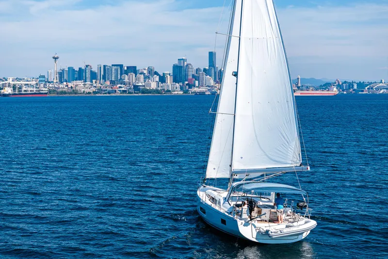 Slide: The Image of Sailing yacht Beneteau Oceanis 46.1, 2019, cruising near a city skyline on a sunny day. - 2