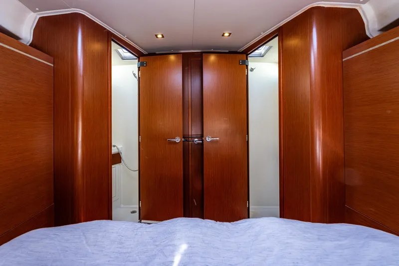 Slide: The Image of Interior of 2019 Beneteau Oceanis 46.1 yacht with wooden cabinetry and ensuite bathroom. - 32