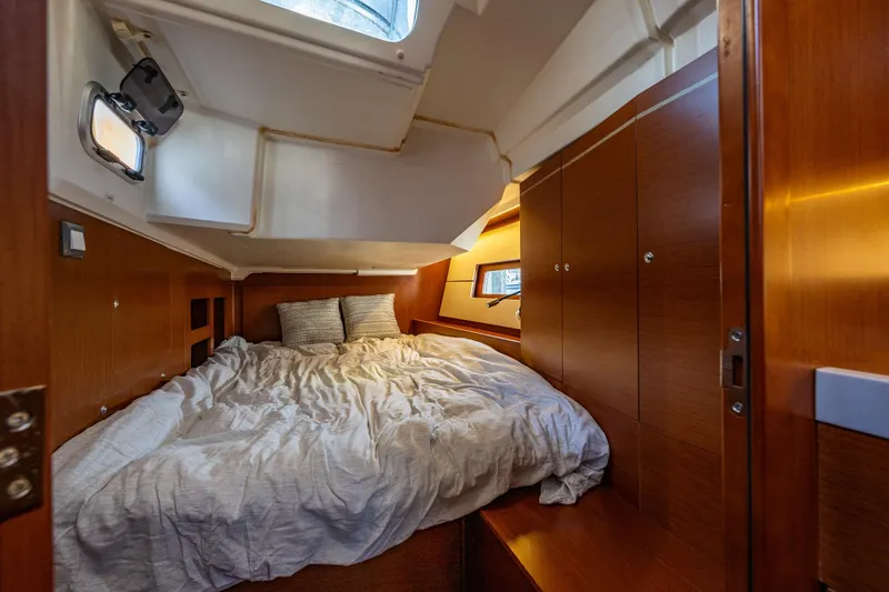 Slide: The Image of Cozy cabin interior of 2019 Beneteau Oceanis 46.1 yacht with wood finish and comfortable bedding. - 28