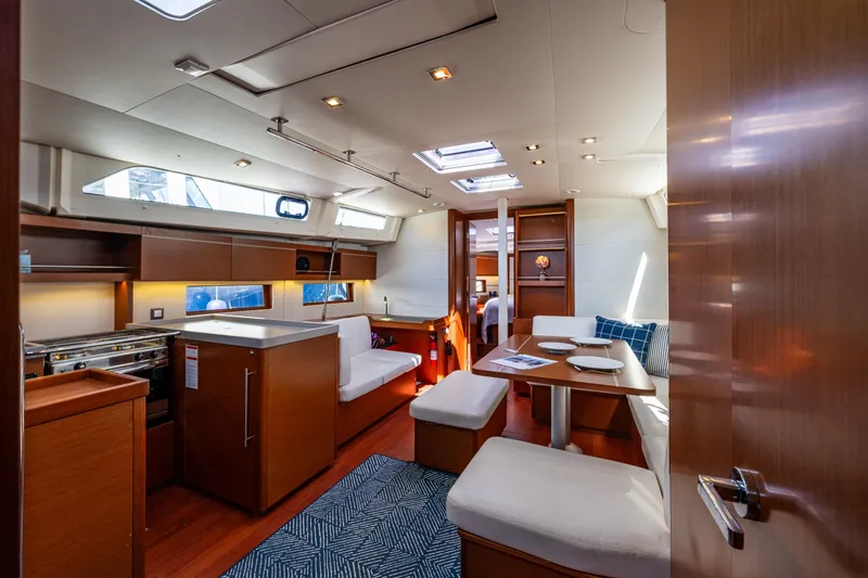 Slide: The Image of Luxurious interior of 2019 Beneteau Oceanis 46.1 yacht, featuring modern kitchen and dining area. - 25