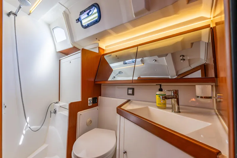 Slide: The Image of Luxurious bathroom in 2019 Beneteau Oceanis 46.1 yacht, featuring modern fixtures and elegant wood accents. - 24