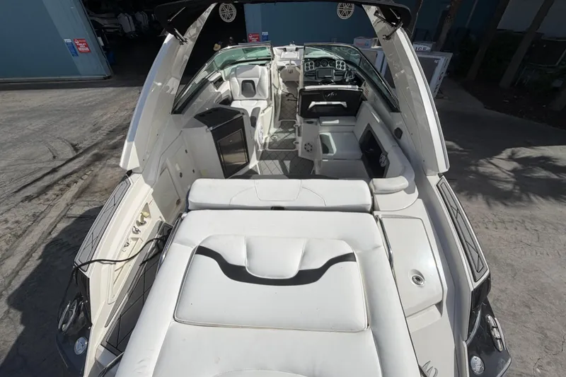 Slide: The Image of 2013 Monterey 328SS Super Sport boat interior with white seating and dashboard. - 16