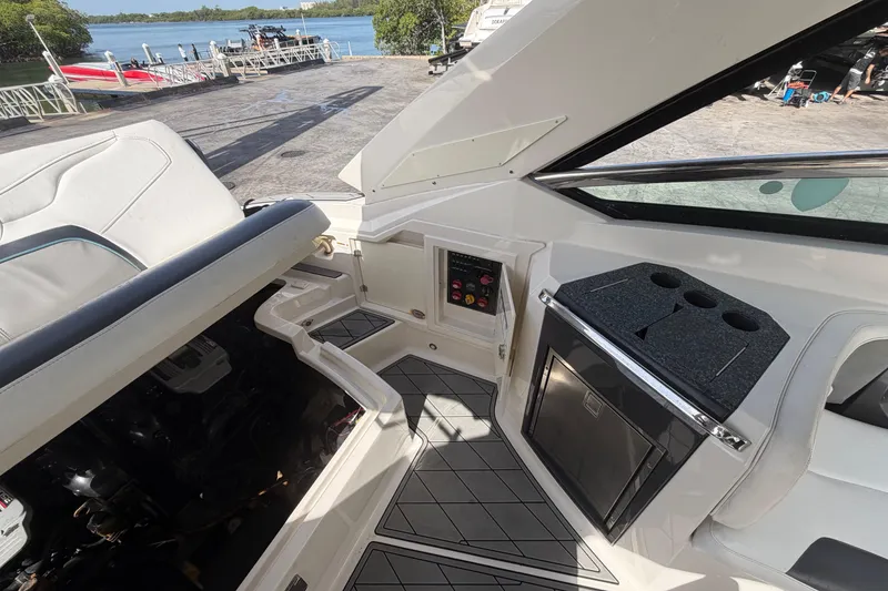 Slide: The Image of Interior of a 2013 Monterey 328SS Super Sport boat with seating and control panel. - 13
