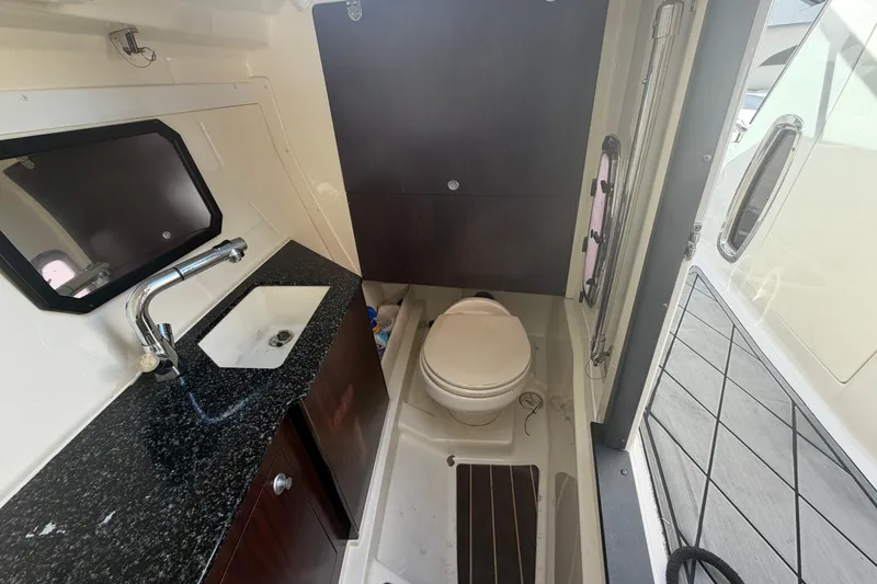 Slide: The Image of 2013 Monterey 328SS Super Sport boat bathroom with sink, toilet, and storage cabinet. - 19