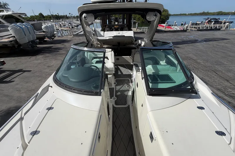 Slide: The Image of 2013 Monterey 328SS Super Sport boat docked at marina, showcasing sleek design and spacious interior. - 18