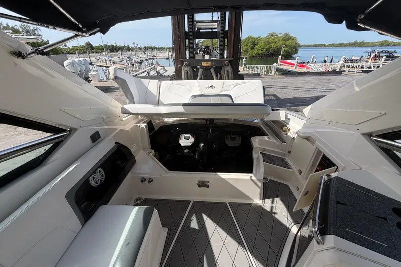 Slide: The Image of 2013 Monterey 328SS Super Sport boat interior with open engine compartment, dockside view. - 8