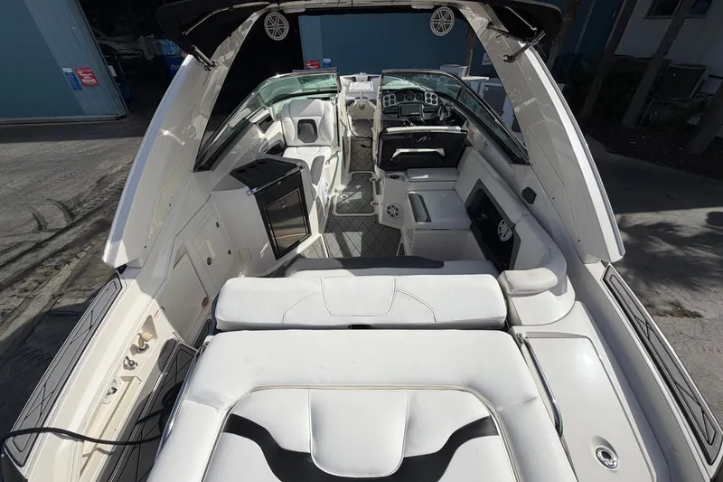 Slide: The Image of Interior view of a 2013 Monterey 328SS Super Sport boat with white seating and modern amenities. - 6