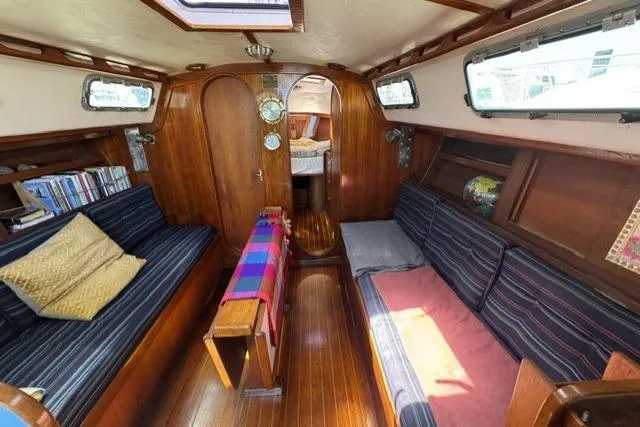 Slide: The Image of Interior of a 1990 J Boats J/37 sailboat with cozy seating and wooden finishes. - 18