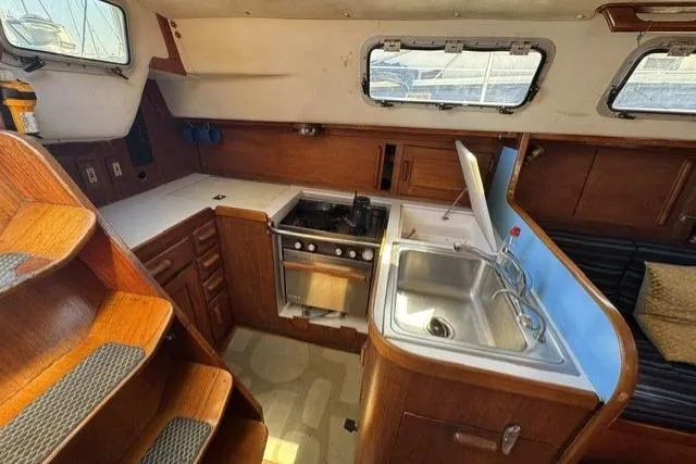 Slide: The Image of Interior of 1990 J Boats J/37 sailboat featuring kitchen with stove and sink. - 23