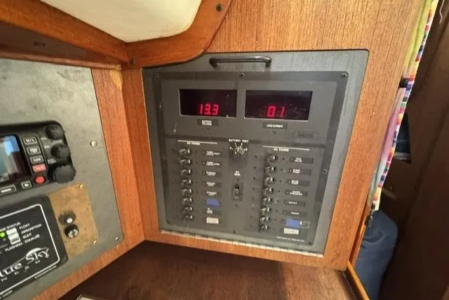 Slide: The Image of Electrical panel of a 1990 J Boats J/37 sailboat, featuring digital displays and switches. - 28