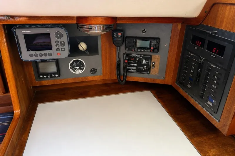 Slide: The Image of Navigation and control panel of a 1990 J Boats J/37 sailboat, featuring various instruments. - 24