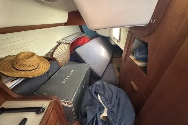 Slide: The Image of Interior of a 1990 J Boats J/37 sailboat with cushions and a straw hat. - 20