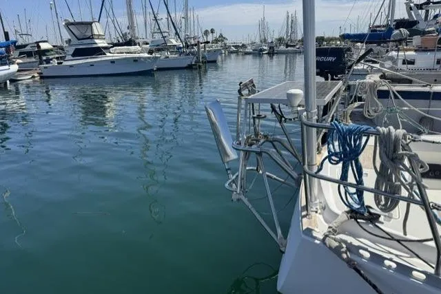 Slide: The Image of 1990 J Boats J/37 sailboat docked in a marina with other vessels. - 5
