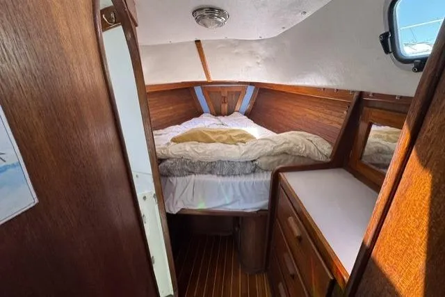Slide: The Image of Cozy cabin interior of 1990 J Boats J/37 with wooden finish and comfortable bedding. - 21