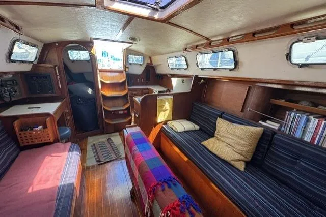 Slide: The Image of Interior of a 1990 J Boats J/37 sailboat with cozy seating and wooden finishes. - 19
