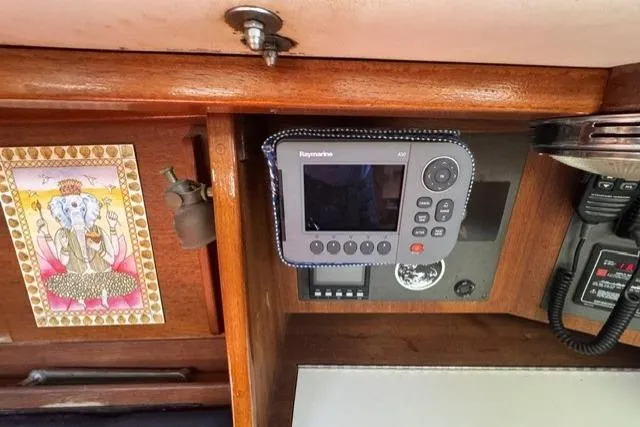 Slide: The Image of Interior of 1990 J Boats J/37 featuring navigation equipment and decorative artwork. - 25