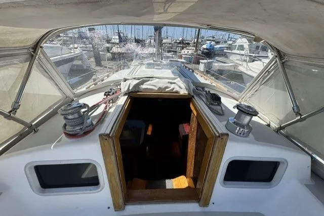 Slide: The Image of 1990 J Boats J/37 sailboat cockpit view with marina background. - 17