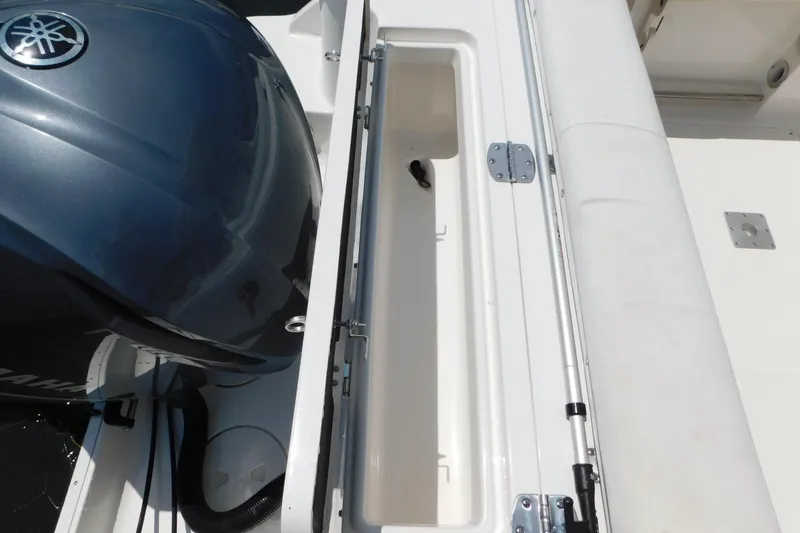 Slide: The Image of 2018 Robalo R247 Dual Console boat with Yamaha engine and storage compartment. - 10